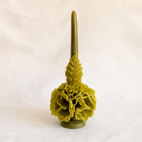 A handcrafted Oaxacan beeswax candle in a rich olive green, featuring intricate floral designs that showcase traditional artistry. This self-standing candle brings a touch of Mexico's cultural heritage to your home, perfect for sustainable and eco-friendly décor.