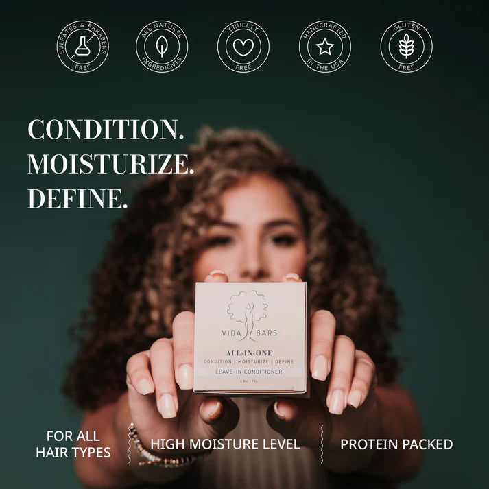 A person holding a box of Vida Bars Leave-In Conditioner, showcasing the eco-friendly packaging. The box design reflects the brand's commitment to sustainability and natural beauty, emphasizing the product's unique handcrafted quality and citrus floral scent.