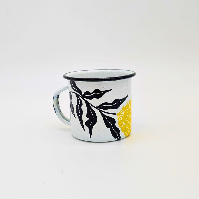 White enamel (Peltre) Cup with vibrant yellow marigold (cempasúchil) designs and black leaf accents, set against a white background.