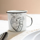 Hearts 12 oz peltre cup. These enamel (peltre) cups by Malte Taller will add a splash of Modern Mexican design to your home while keeping it sustainable. The unique designs are hand drawn by a pair of sisters and inspired by the art of Michoacán, Mexico.    Made for everyday use, these durable cups are great for your daily cafecito, agua fresca, or your next picnic or camping trip. Your purchase also supports women artisans working to preserve the art of traditional peltre with a modern aesthetic.