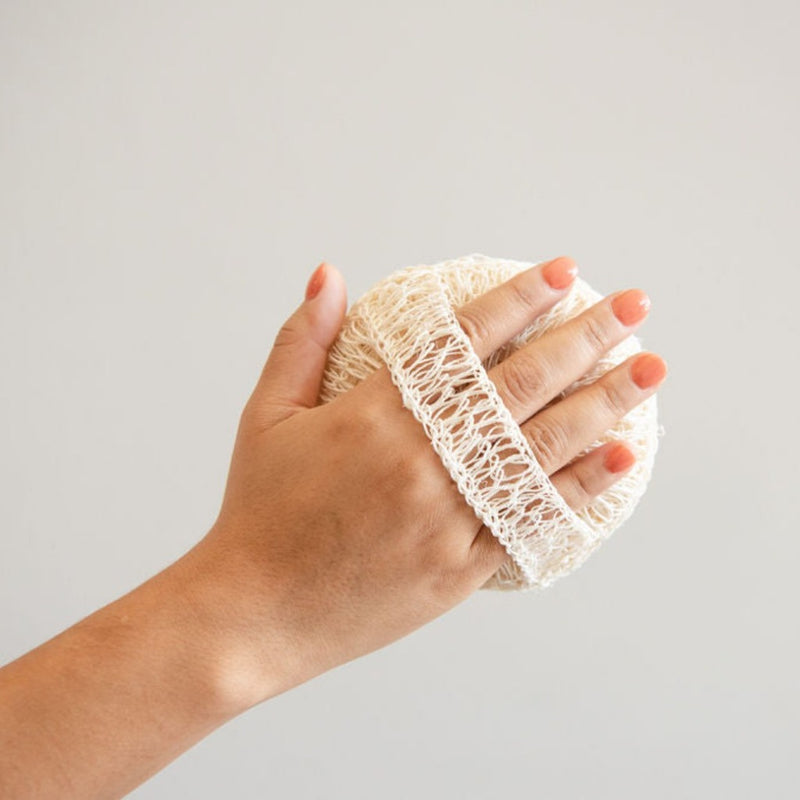 Agave Body Sponge with a strap on a hand for ergonomic hold