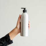 zero-waste refillable biodegradable shampoo in aluminum dispenser