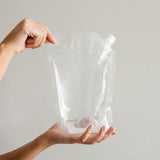 A hand holding 32 oz bulk refill pouch for zero waste hand soap or dish soap