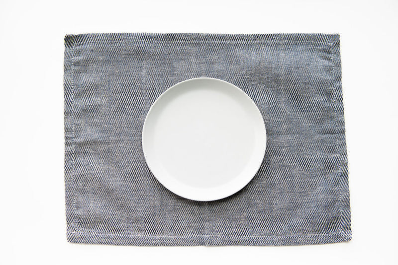 Blue and Beige Cotton Woven placemat with plate on it. 